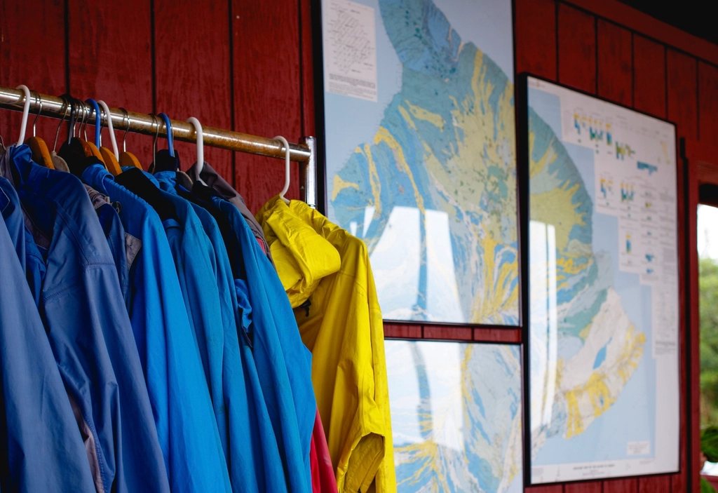 Rain jackets hanging on a coat rack